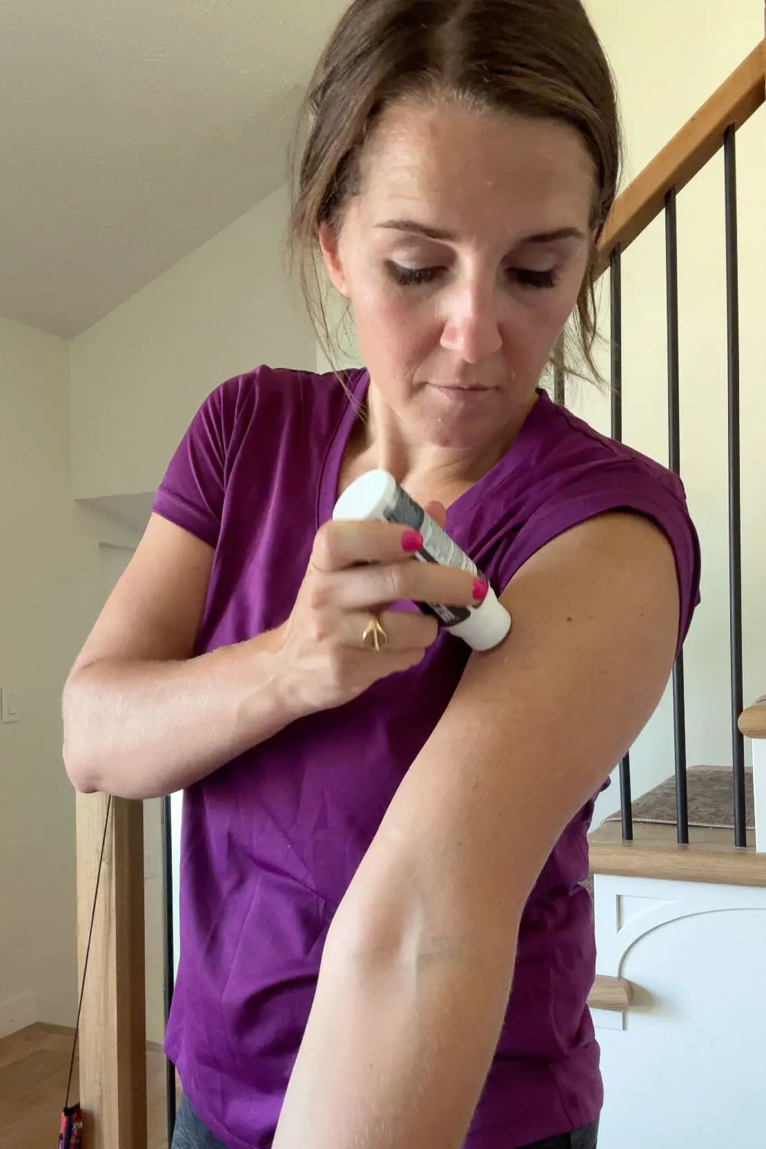 Woman applying CryoFreeze Hemp Roll-On to her arm for fast-acting, natural muscle and joint pain relief.